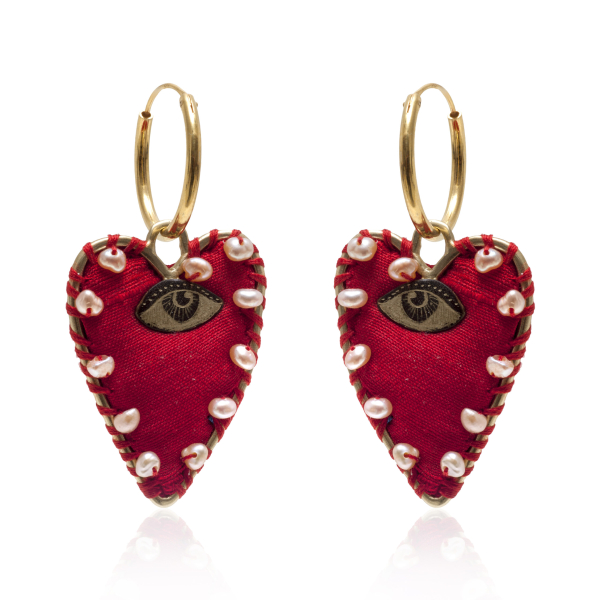 a pair of red heart shaped earrings